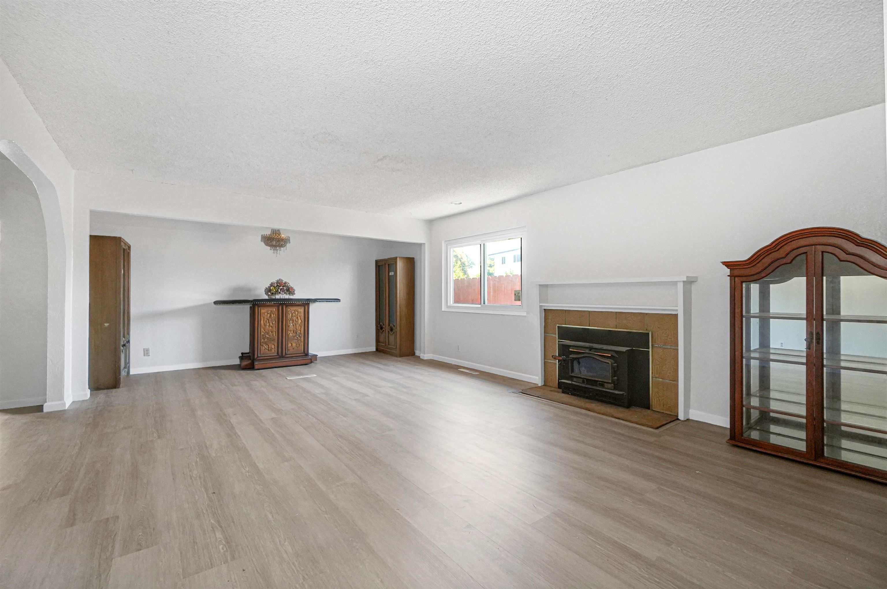 512 Teasdale Place Hayward, CA 94544 - Photo 15 of 58 a view of empty room with wooden floor and fireplace