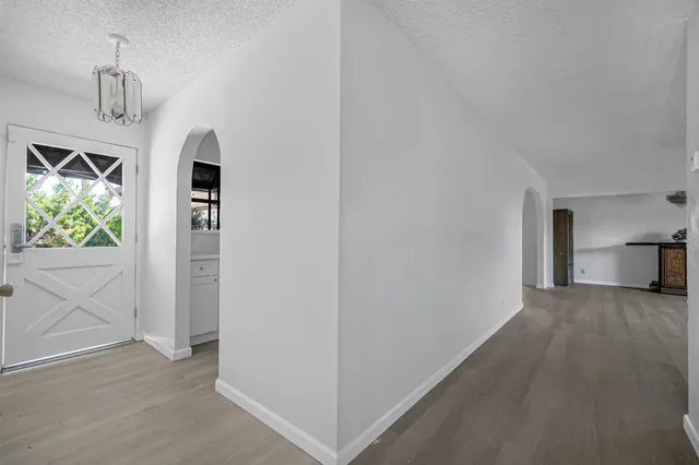 a kitchen with a refrigerator sink and cabinets