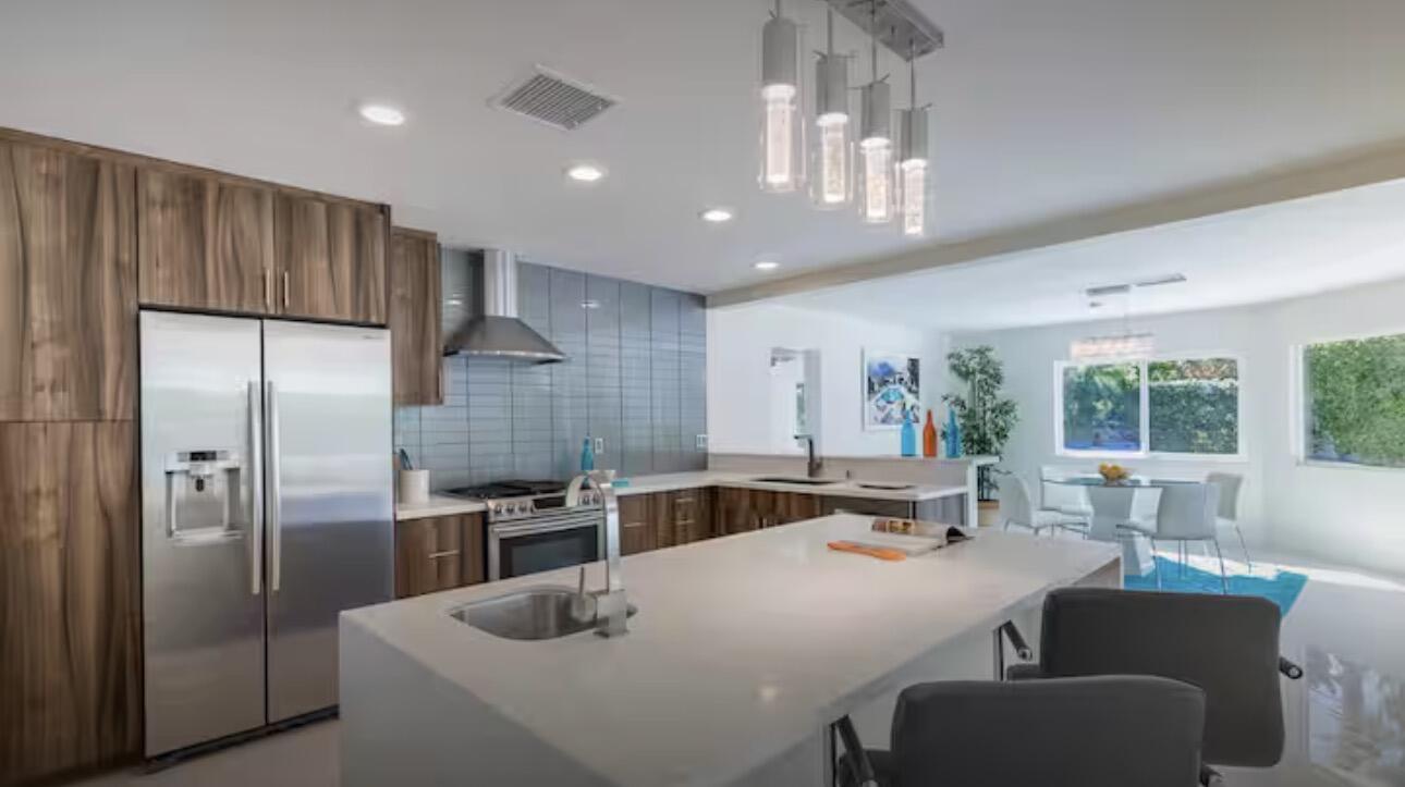 1375 South Calle Rolph Palm Springs, CA 92264 - Photo 12 of 19 a kitchen with stainless steel appliances granite countertop a sink refrigerator and cabinets