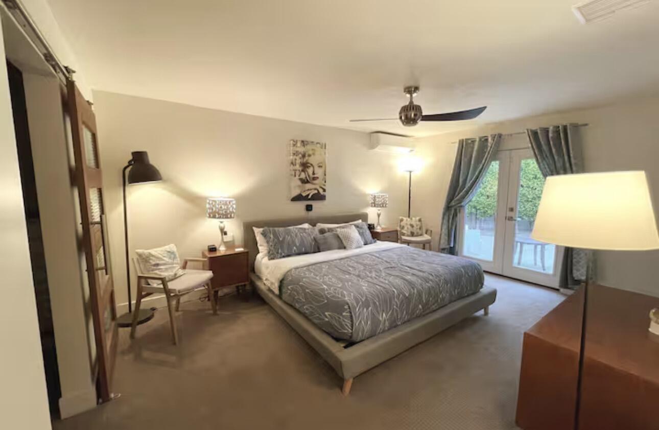 1375 South Calle Rolph Palm Springs, CA 92264 - Photo 4 of 19 a spacious bedroom with a bed window and a lamp