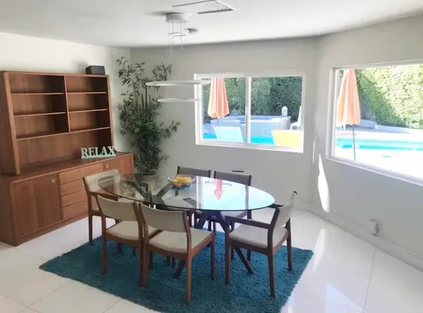 a living room with furniture and a view of kitchen
