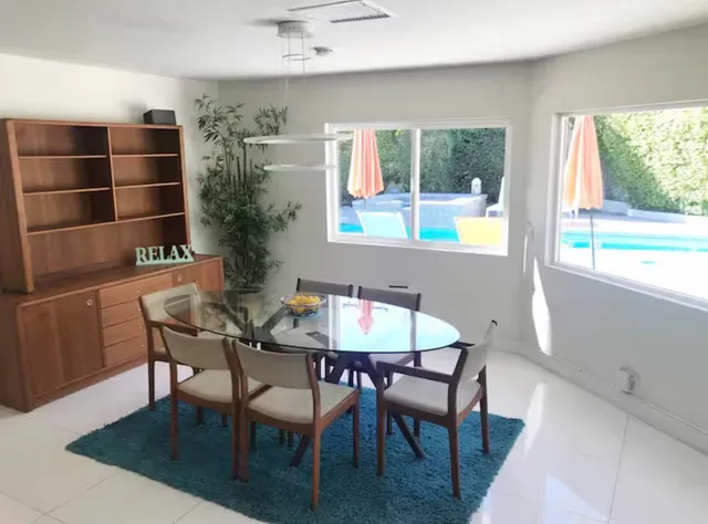 a living room with furniture and a view of kitchen