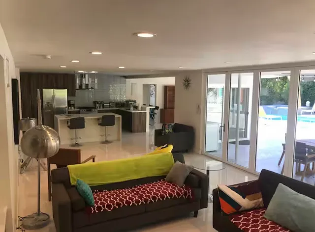 a backyard of a house with table and chairs