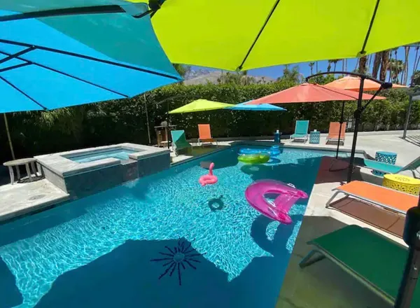 a view of the patio with a table and chairs under an umbrella