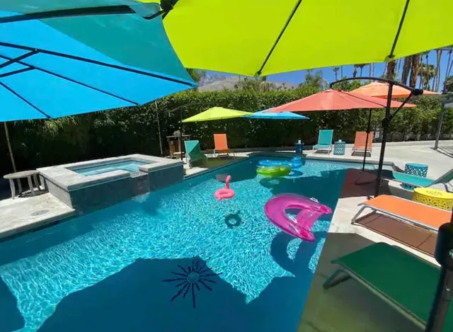 a view of the patio with a table and chairs under an umbrella