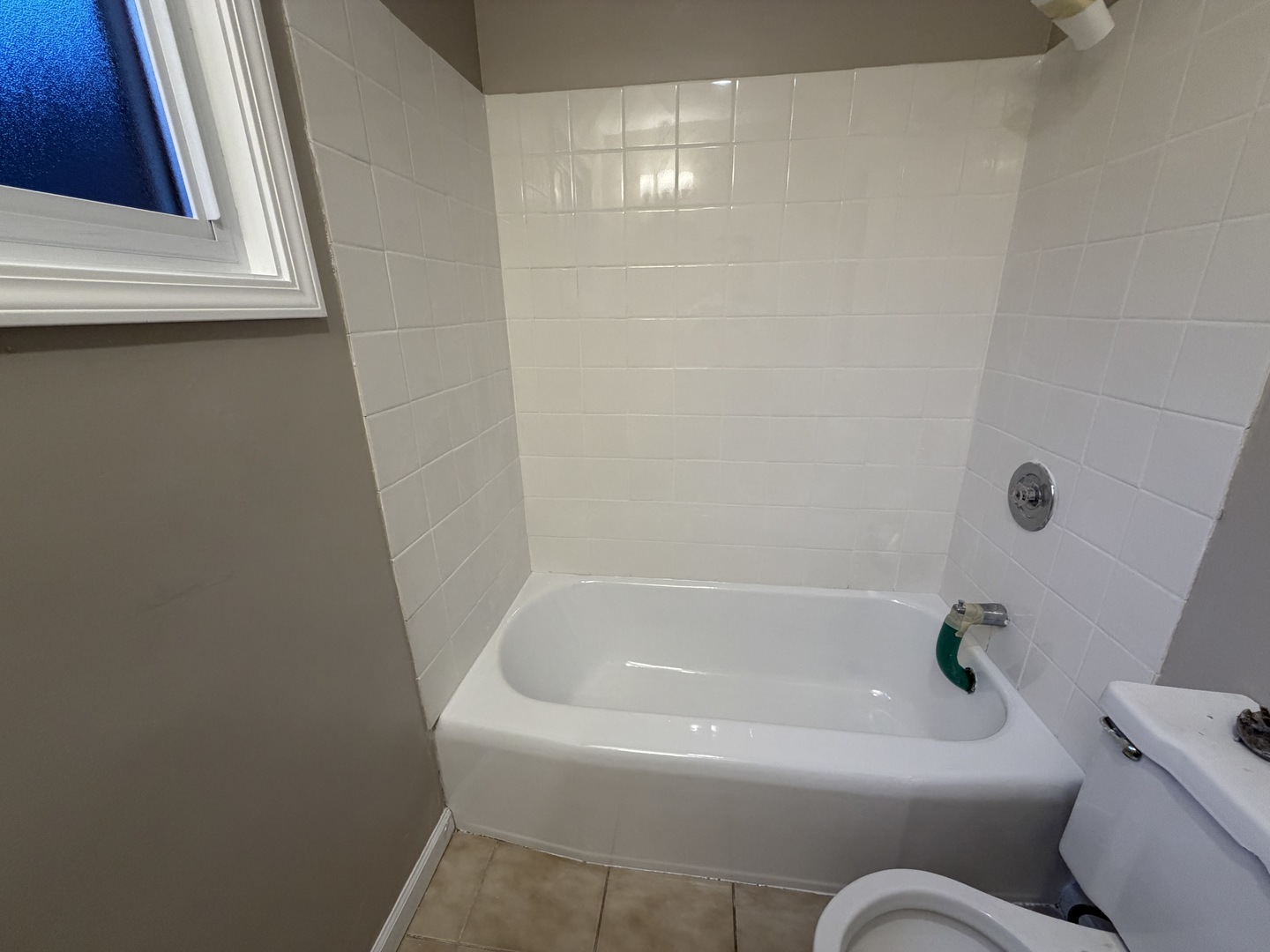 1605 Monroe Street, Unit 1 Evanston, IL 60202 - Photo 4 of 14 a white bath tub sitting next to a white toilet