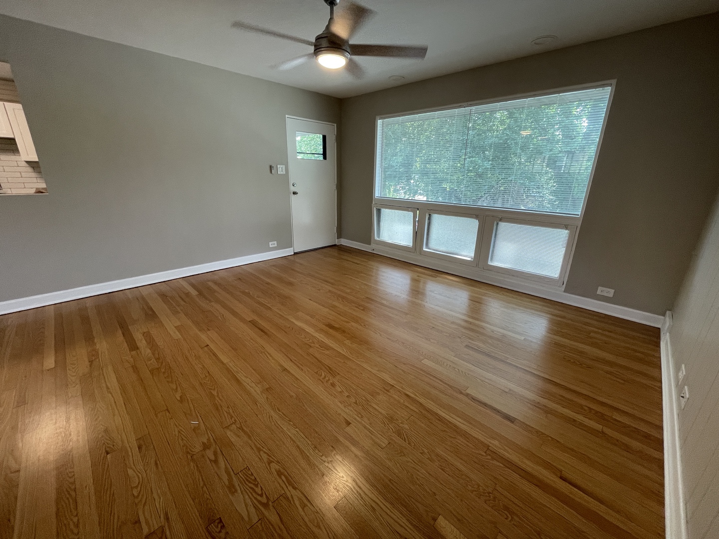 1605 Monroe Street, Unit 1 Evanston, IL 60202 - Photo 6 of 14 a view of empty room with wooden floor and fan