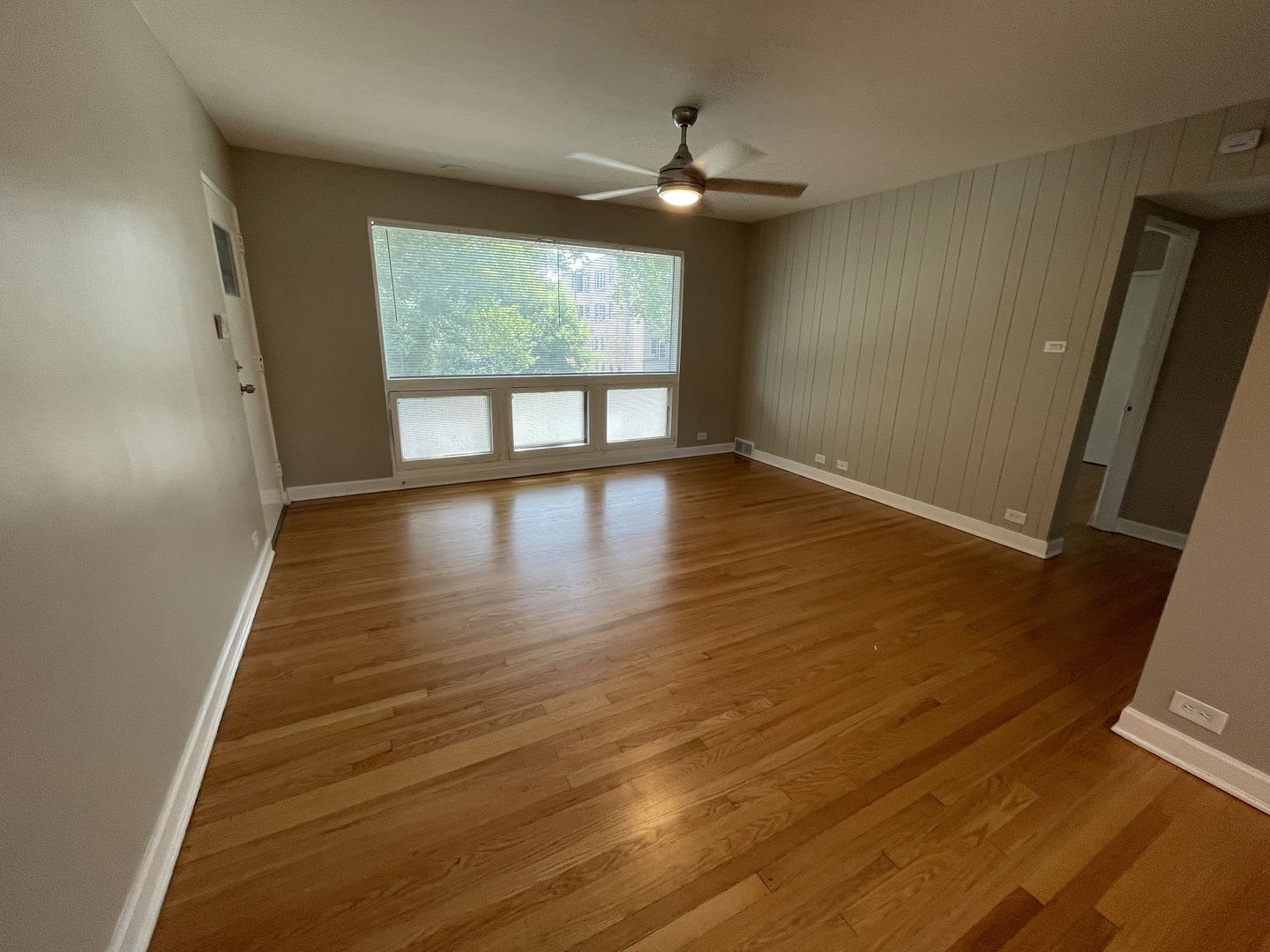 1605 Monroe Street, Unit 1 Evanston, IL 60202 - Photo 7 of 14 an empty room with wooden floor and windows