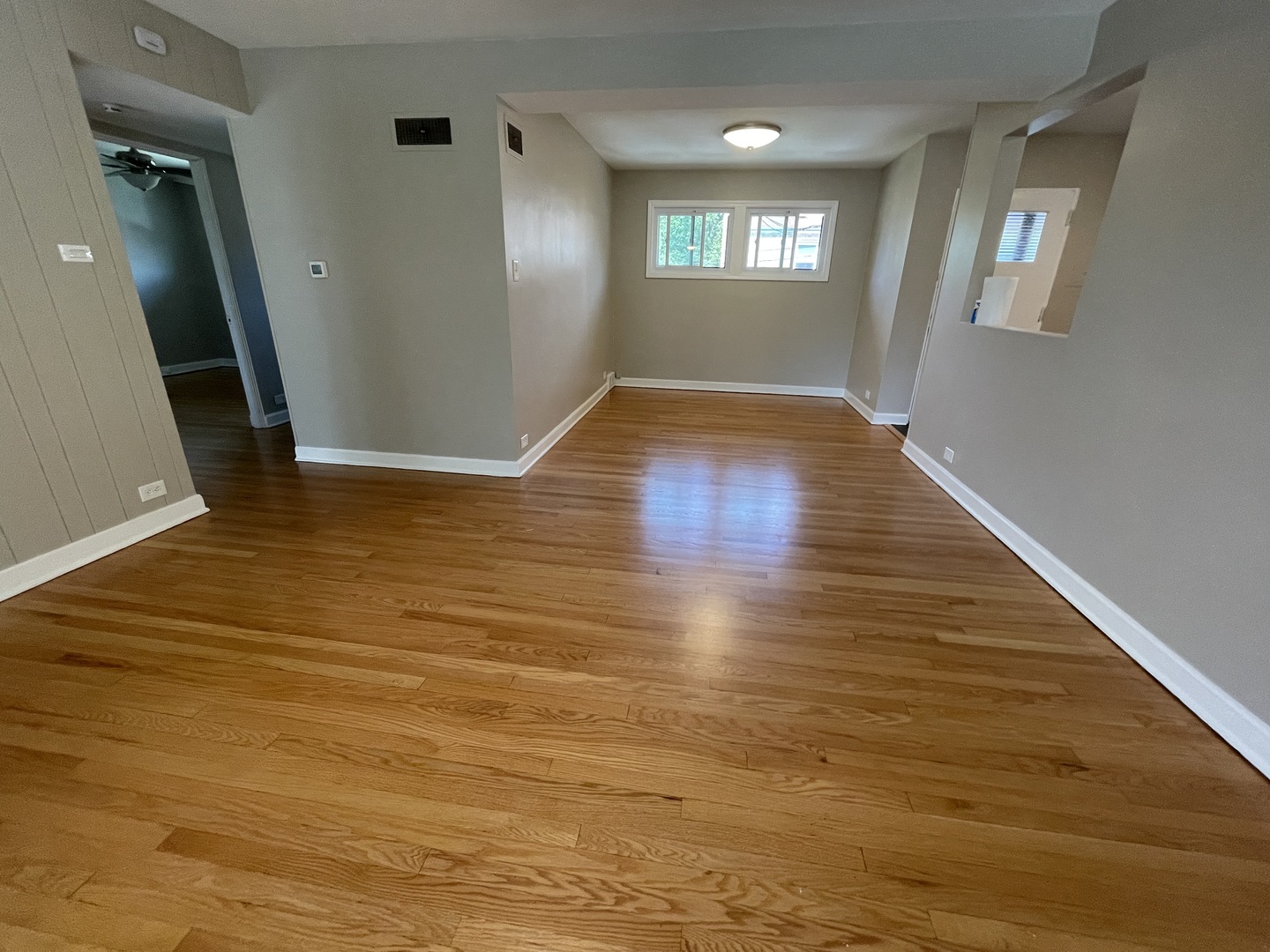 1605 Monroe Street, Unit 1 Evanston, IL 60202 - Photo 8 of 14 a view of an empty room with wooden floor and a window