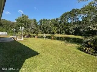 a view of a lake with a yard
