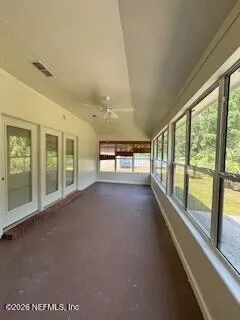 a view of empty room with floor to ceiling windows