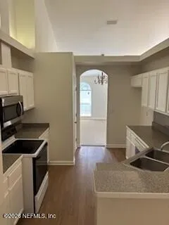 a kitchen with a refrigerator and a stove top oven