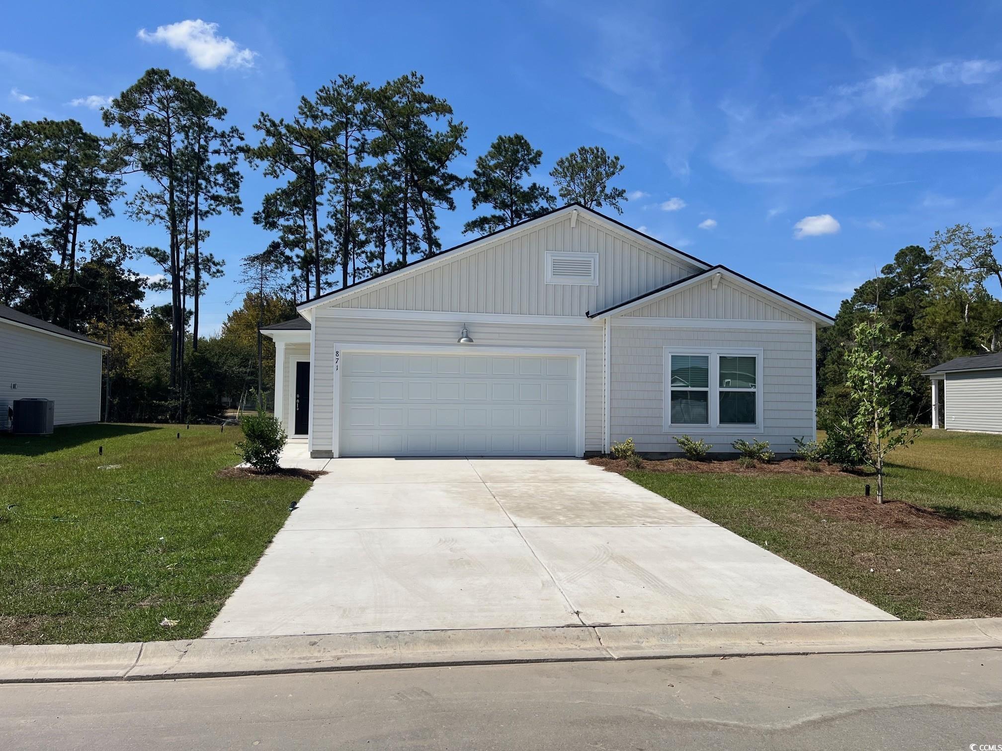 871 Long Bch Loop Longs, SC 29568 - Photo 1 of 20 Ranch-style house featuring driveway, a front yard, a garage, and board and batten siding