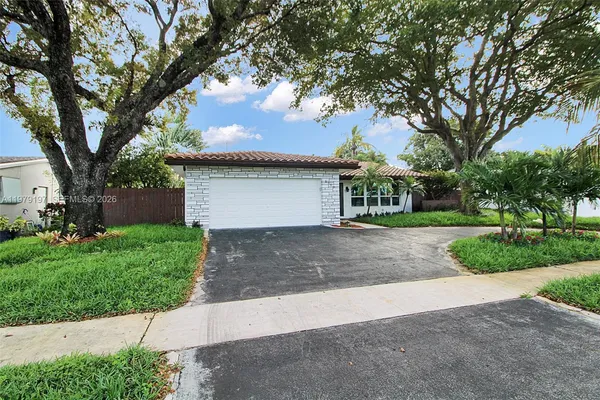 a front view of house with yard and trees