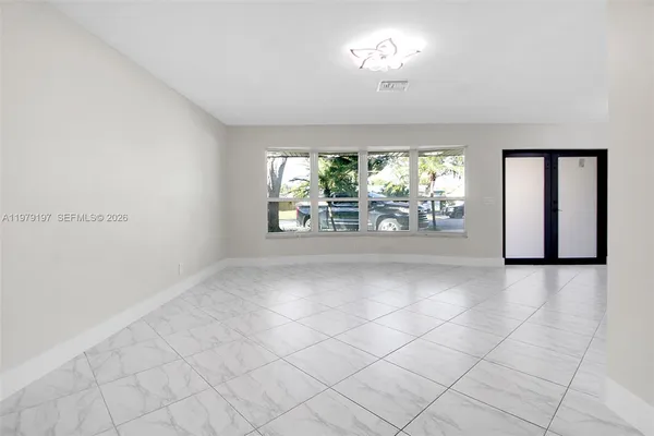 a view of an empty room with a window