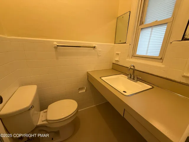 a bathroom with a sink toilet and mirror