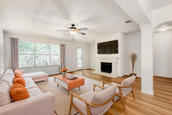 a living room with furniture a fireplace and a flat screen tv