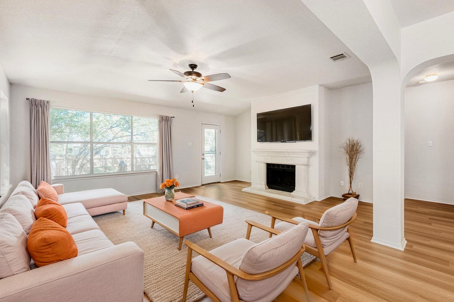 a living room with furniture a fireplace and a flat screen tv