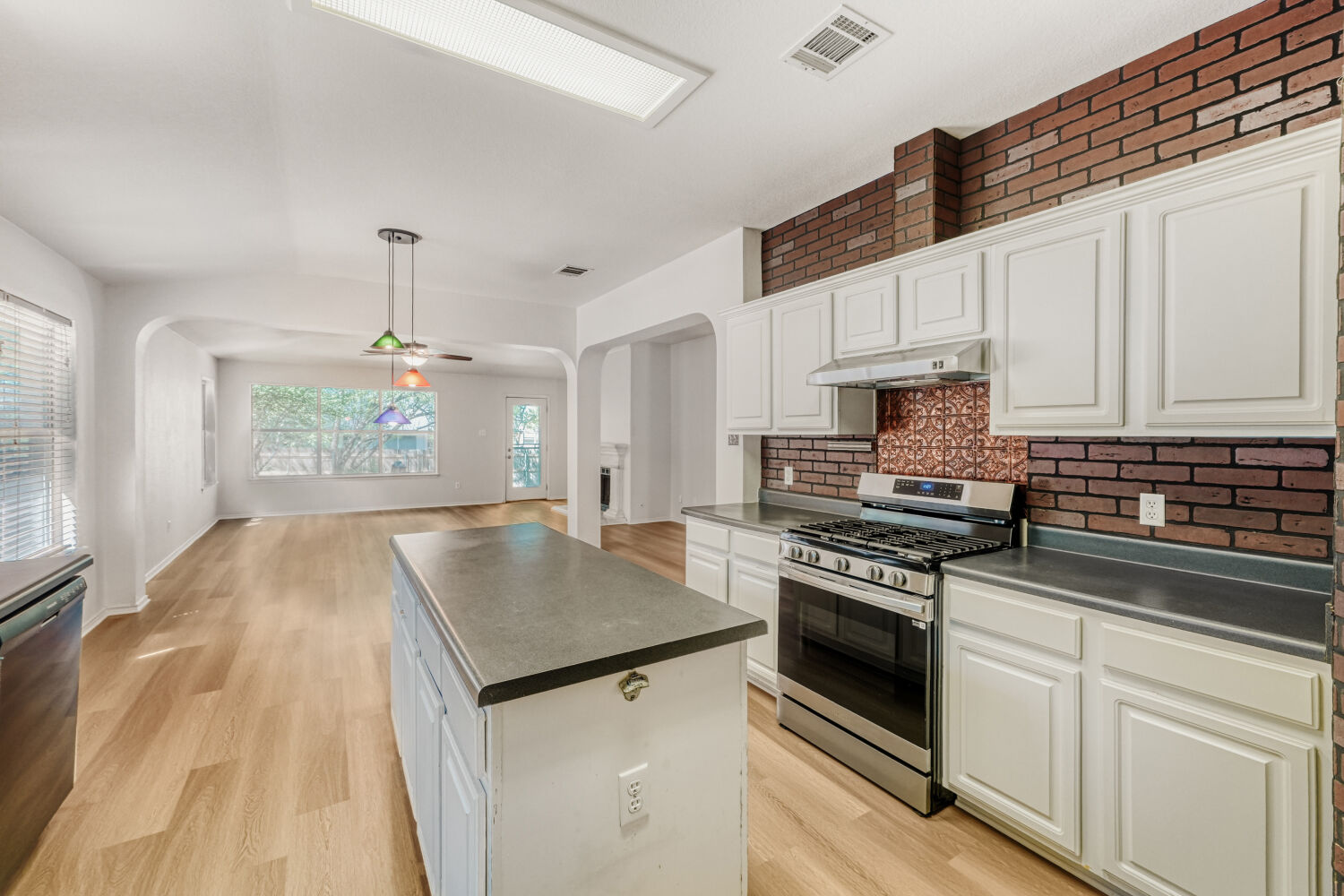 1205 Machado Road Cedar Park, TX 78613 - Photo 11 of 30 a kitchen with granite countertop a stove sink and cabinets