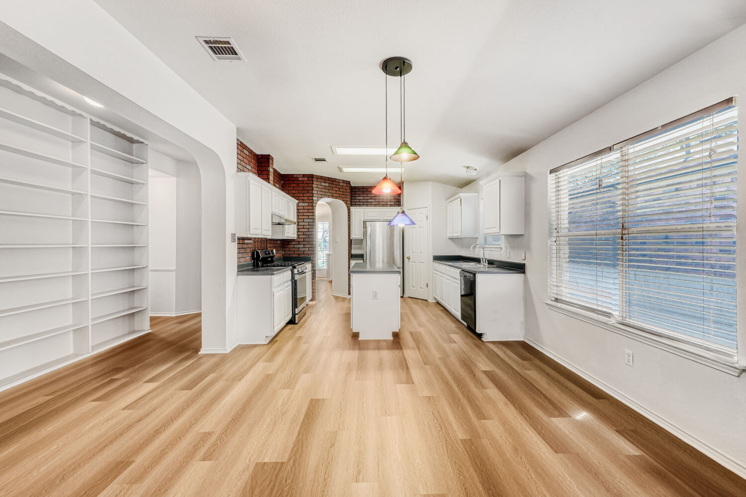 1205 Machado Road Cedar Park, TX 78613 - Photo 12 of 30 a large kitchen with stainless steel appliances granite countertop a lot of counter space and wooden floors