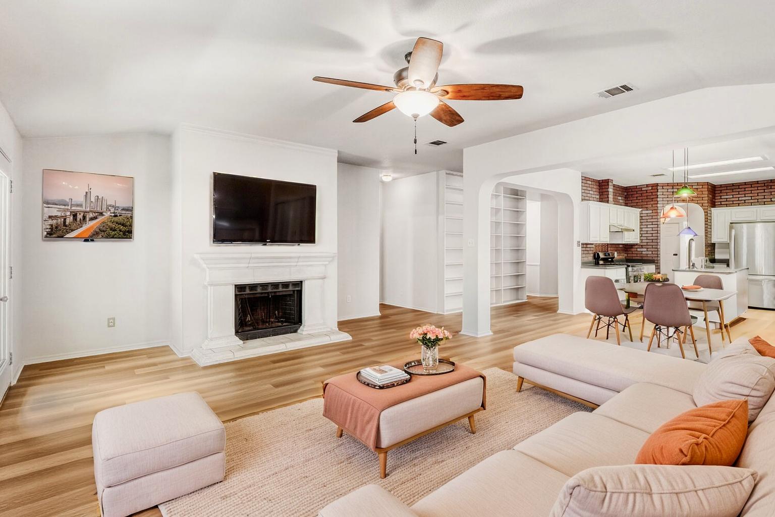 1205 Machado Road Cedar Park, TX 78613 - Photo 14 of 30 a living room with furniture a fireplace and a flat screen tv