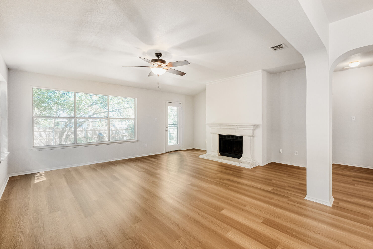 1205 Machado Road Cedar Park, TX 78613 - Photo 16 of 30 an empty room with wooden floor fireplace and windows