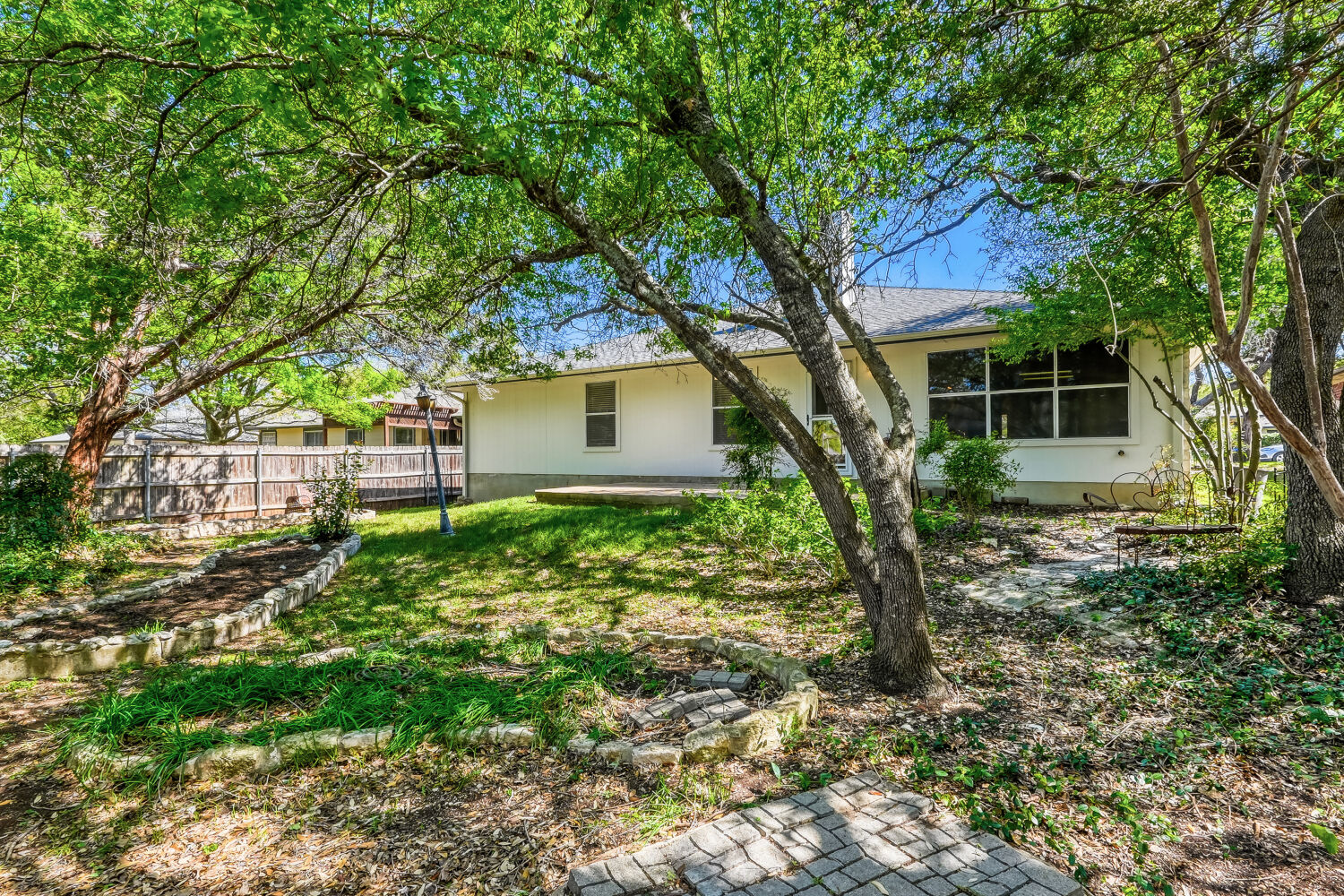 1205 Machado Road Cedar Park, TX 78613 - Photo 29 of 30 a tree in front of a house with a large tree