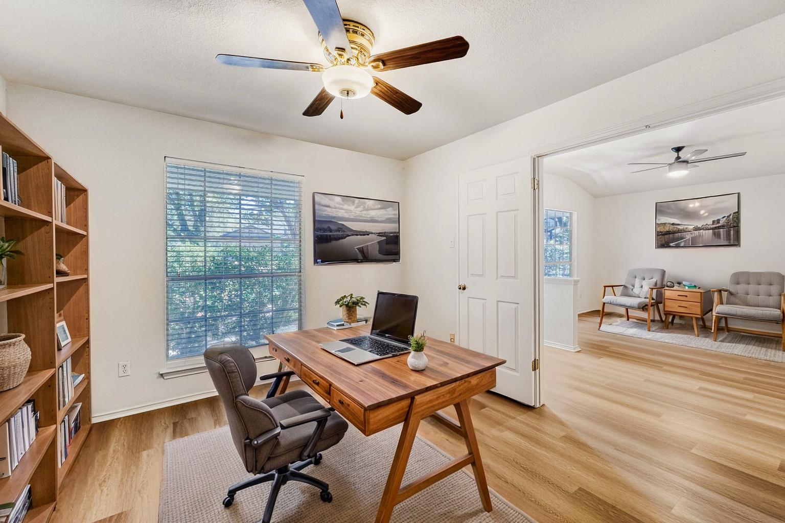 1205 Machado Road Cedar Park, TX 78613 - Photo 4 of 30 a workspace with furniture window and wooden floor