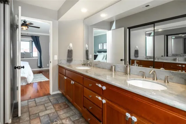 a bathroom with a granite countertop sink mirror and double