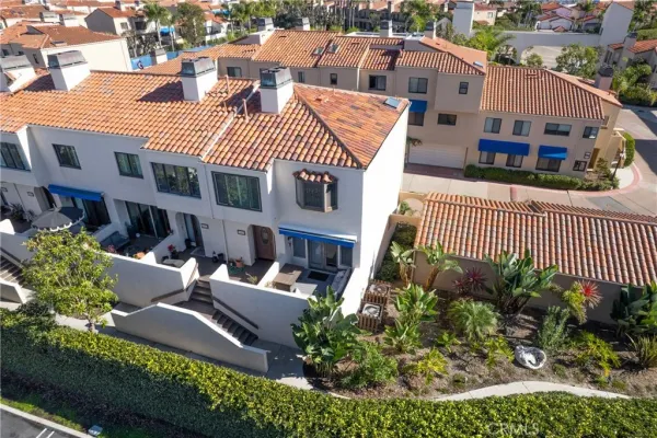 an aerial view of a house with a yard and potted plants