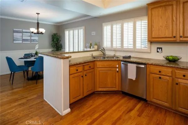 a kitchen with sink cabinets and wooden floor