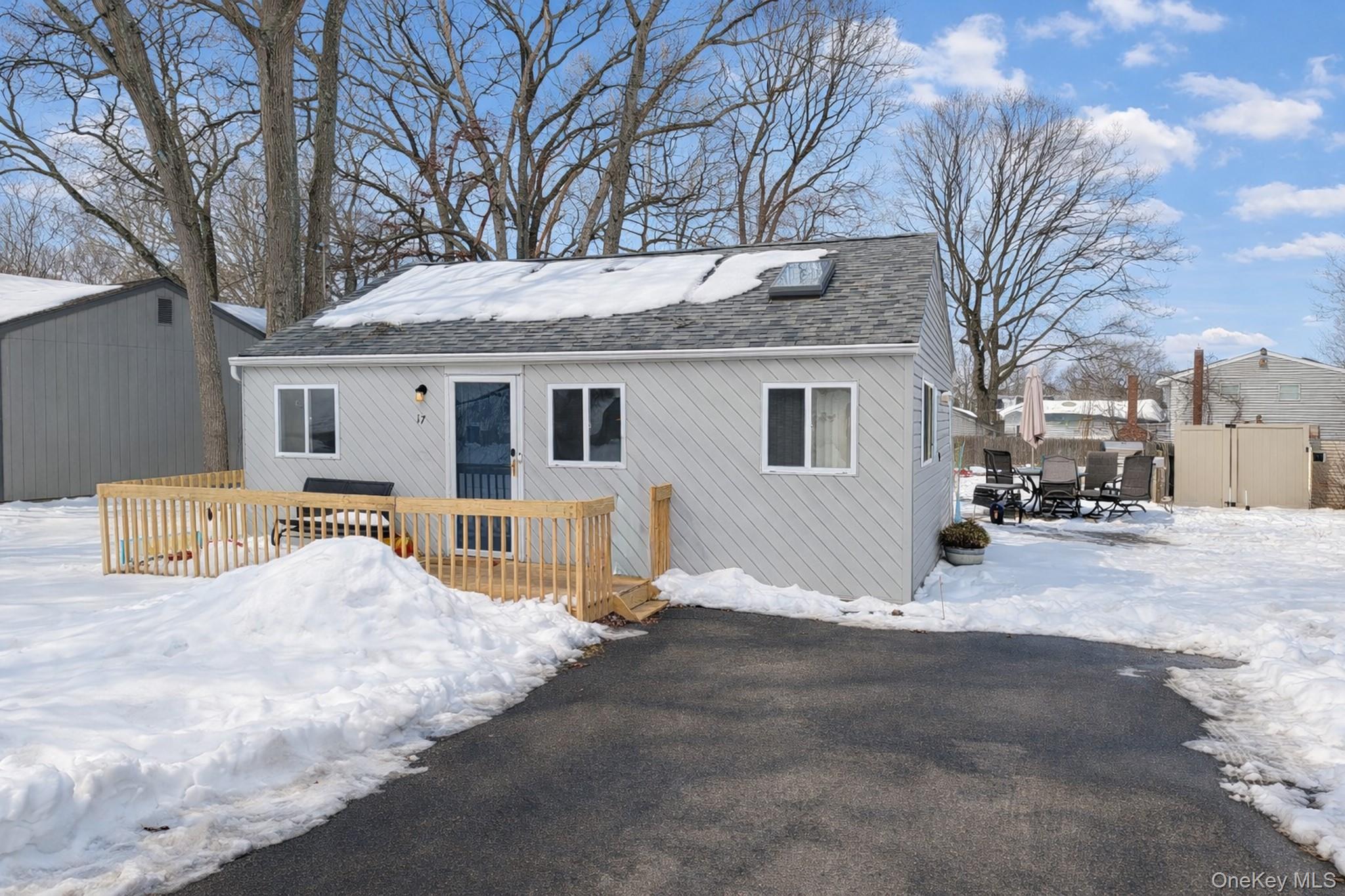 a view of a house with snow on the road