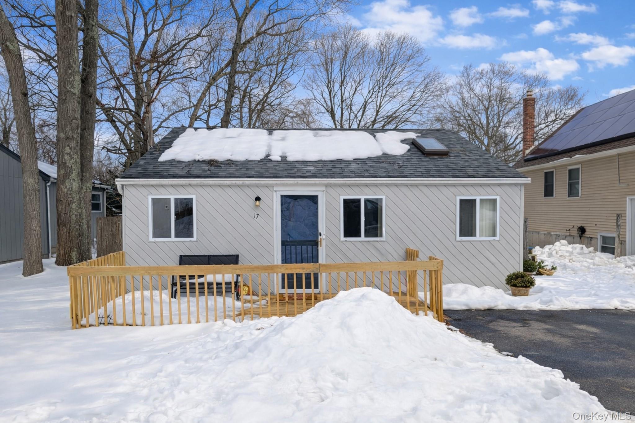 17 Oneida Avenue Selden, NY 11784 - Photo 2 of 12 a front view of a house with a yard covered with snow in front of house