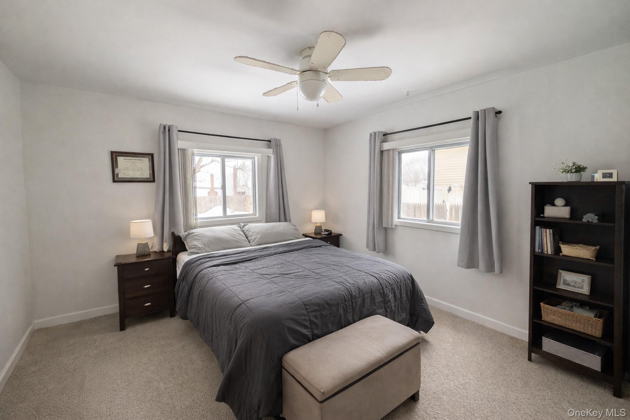 17 Oneida Avenue Selden, NY 11784 - Photo 6 of 12 a bedroom with a bed and a window