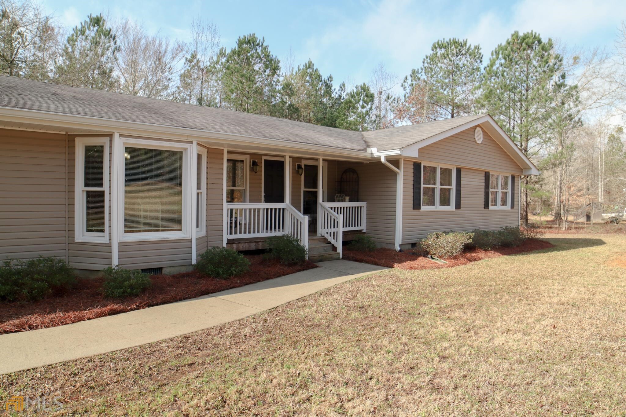 2278 Mountain View Road Meansville, GA 30256 - Photo 1 of 1 a front view of a house with a yard and potted plants