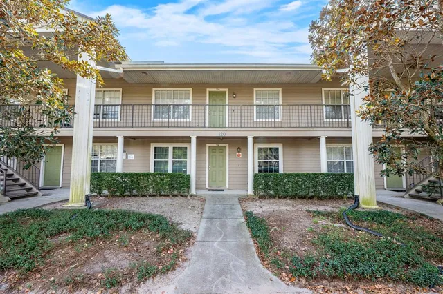 a front view of a house with garden and garage
