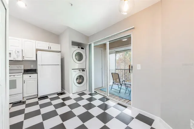 a kitchen with a refrigerator a stove and a sink