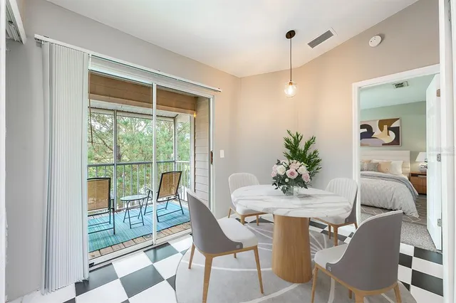 a dining room with furniture window and wooden floor