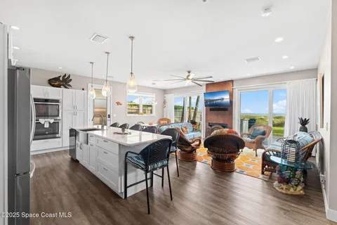 a view of a dining hall with living room and stainless steel appliances