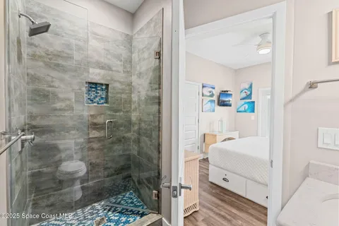 a view of washer and dryer with bathroom in the background