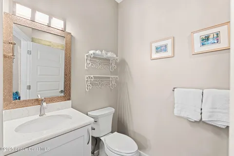 a bathroom with a sink toilet and mirror