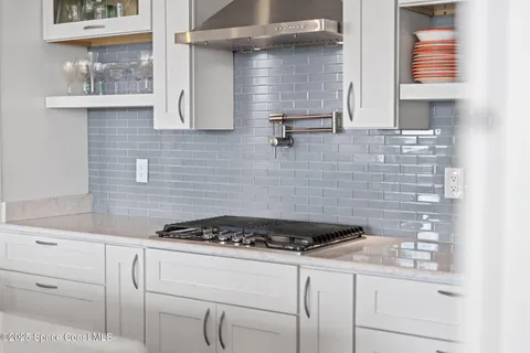 a kitchen with a stove and cabinets