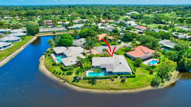 a aerial view of a house with a garden and lake view
