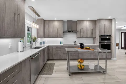 an aerial view of house with yard swimming pool and ocean view