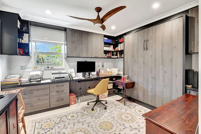 a dining room with furniture a flat screen tv and a floor to ceiling window