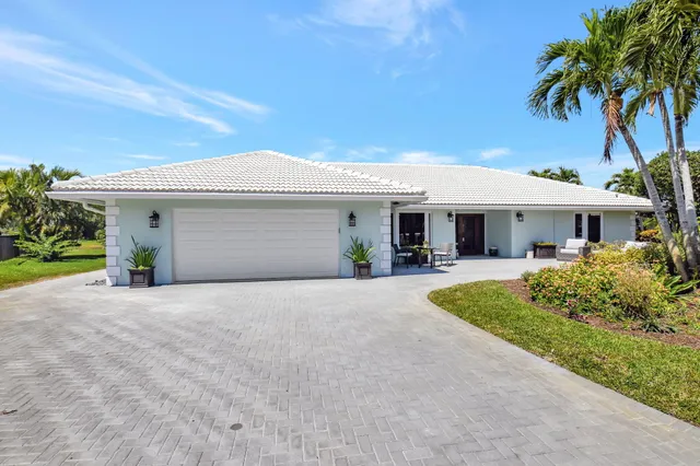 a view of a patio with table and chairs and potted plants