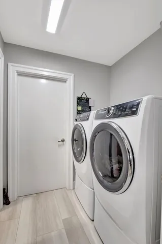 an aerial view of residential houses with outdoor space and swimming pool
