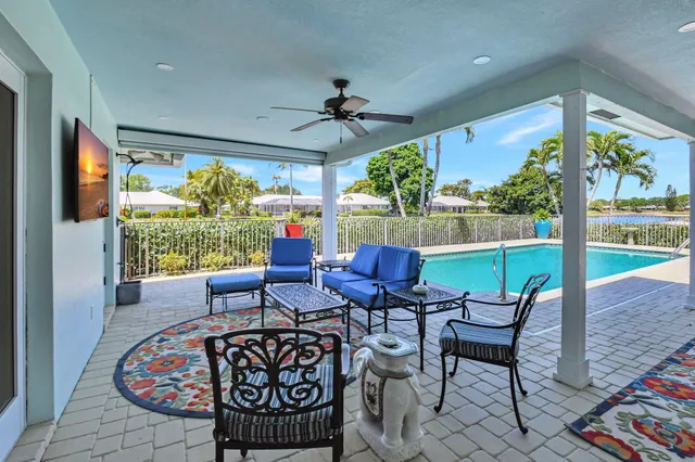 an aerial view of a house with a swimming pool yard and outdoor seating