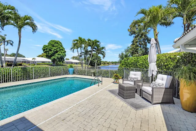 an aerial view of a house with swimming pool garden and patio