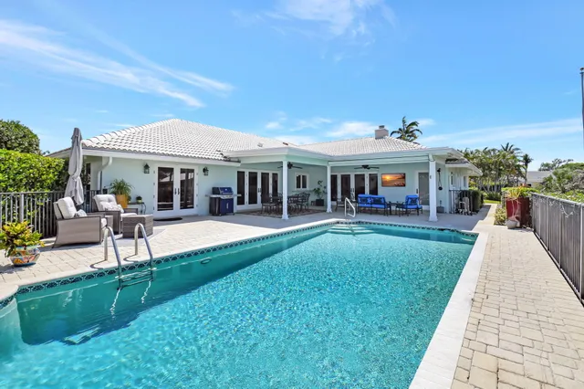 an aerial view of residential houses with outdoor space and trees